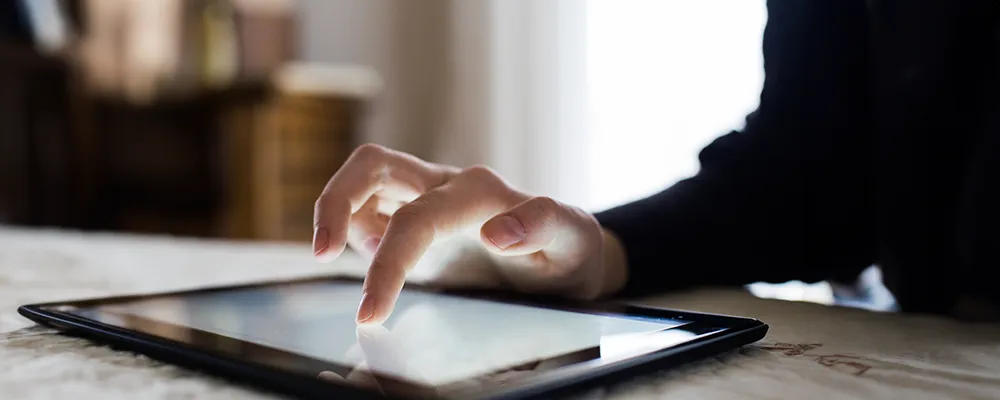 Person scrolling on tablet 