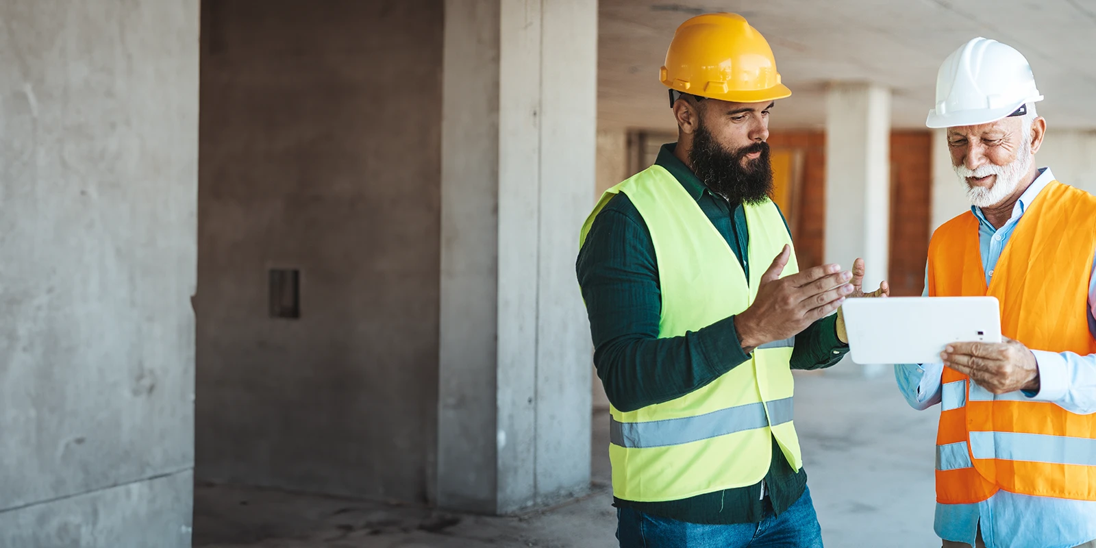 Construction company owner reveiwing documents with an employee.