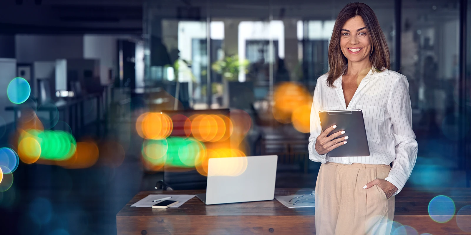 business woman holding a tablet in a modern office