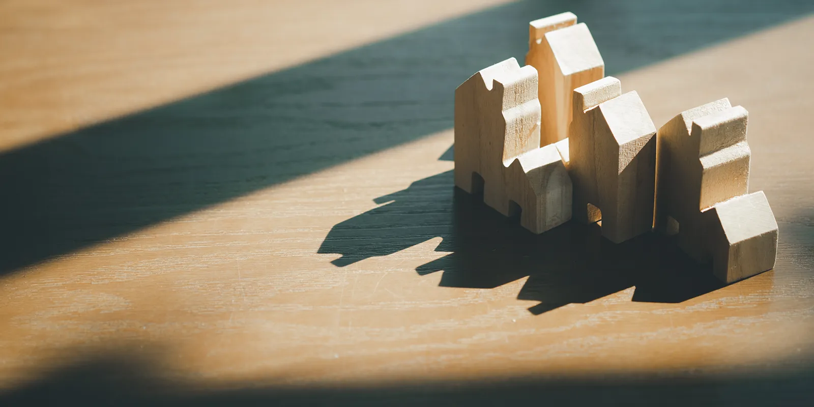 wooden housing models catching shadows