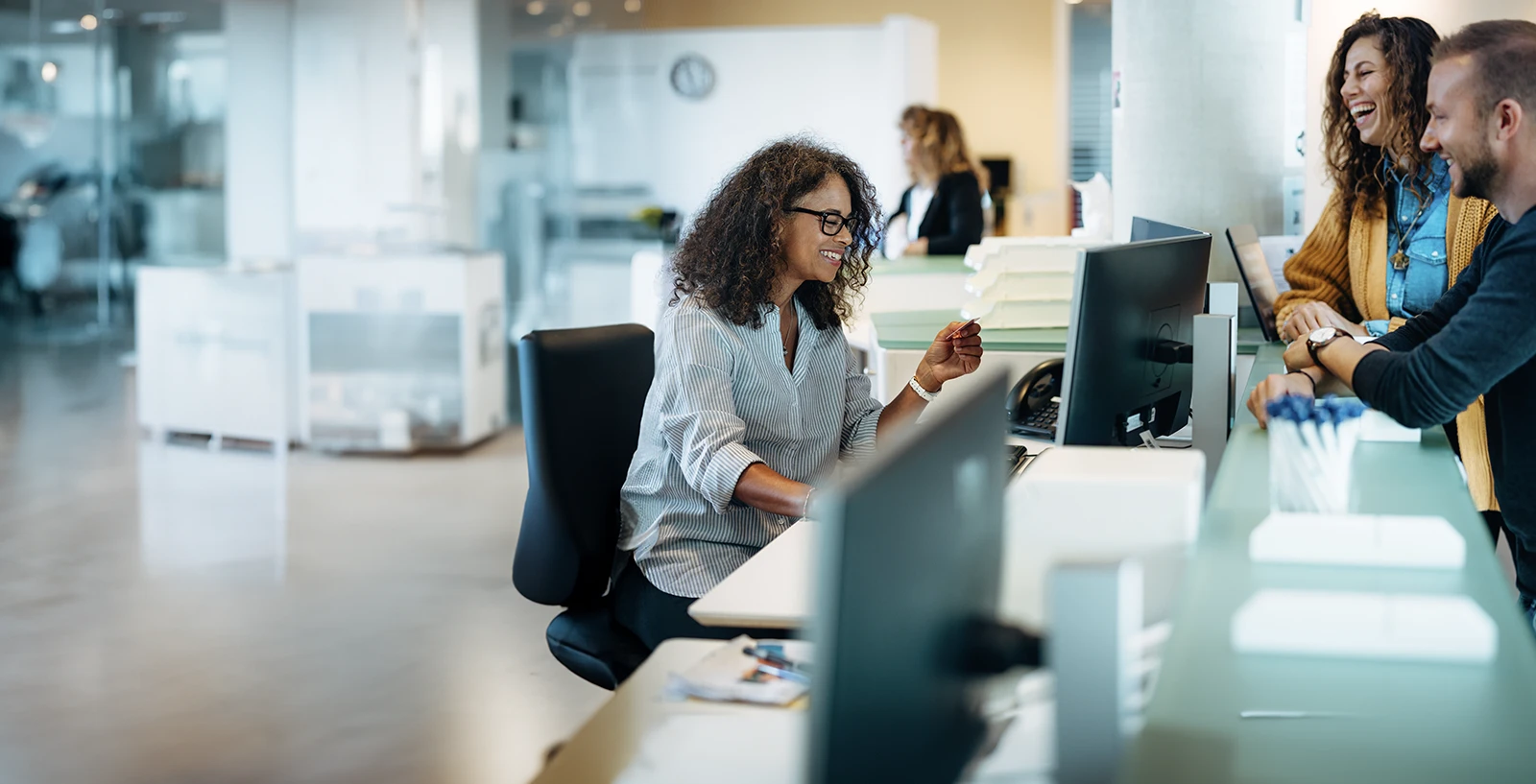 municipal worker helping two customers at a desk