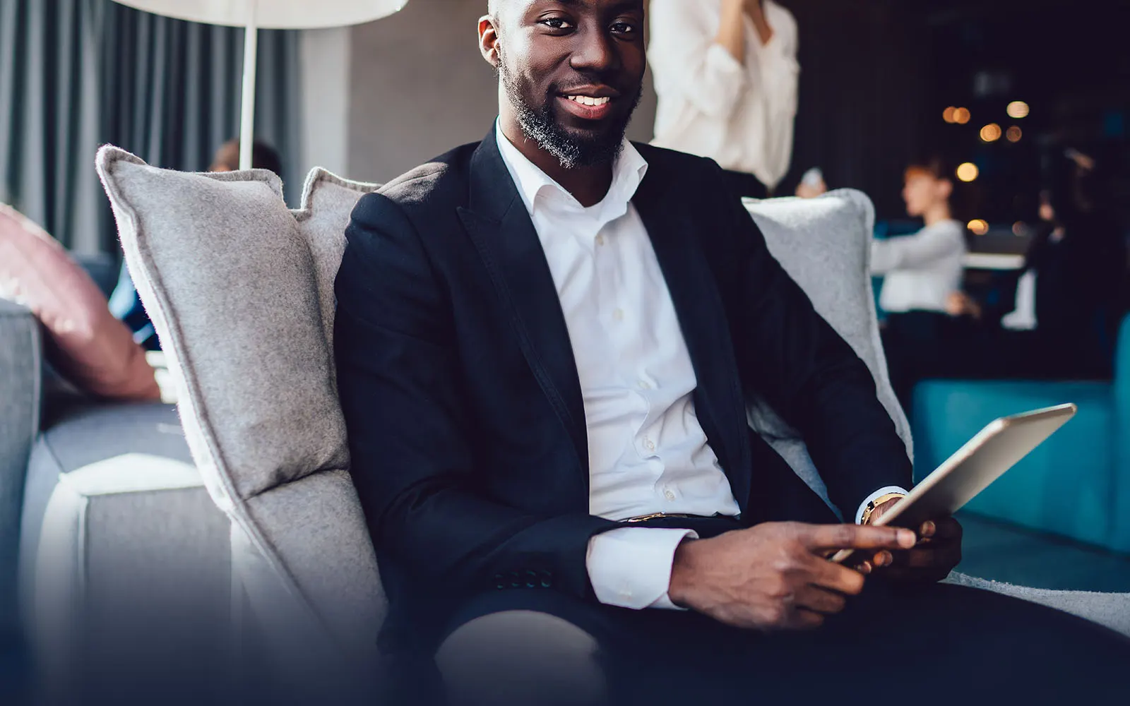 business man working on a tablet in a lounge