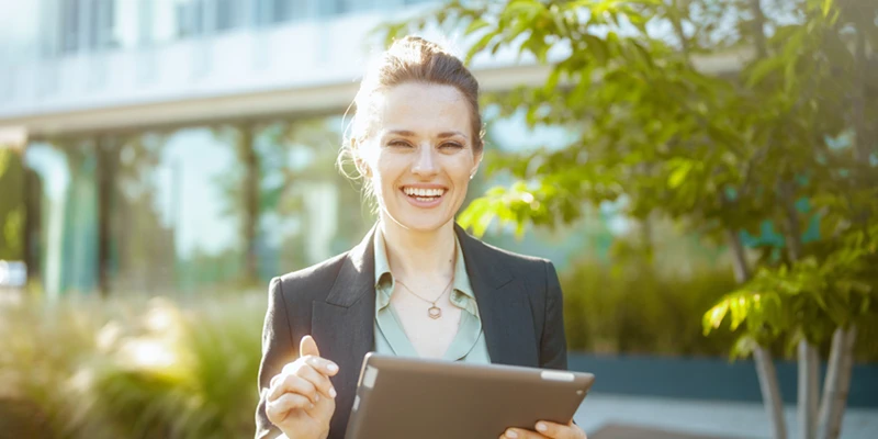 Woman standing outside with ipad in her hand