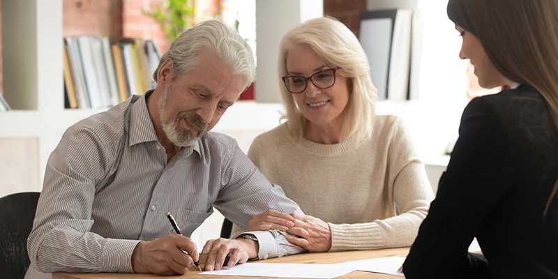 Older couple signing a contact