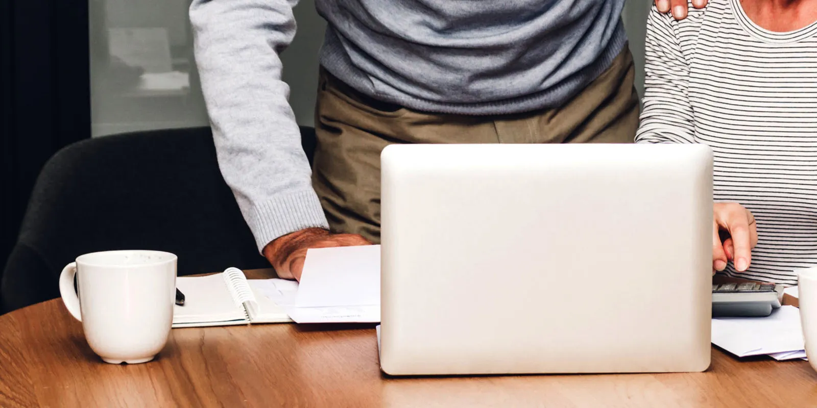 person working on a laptop reviewing  bare trust reporting updates