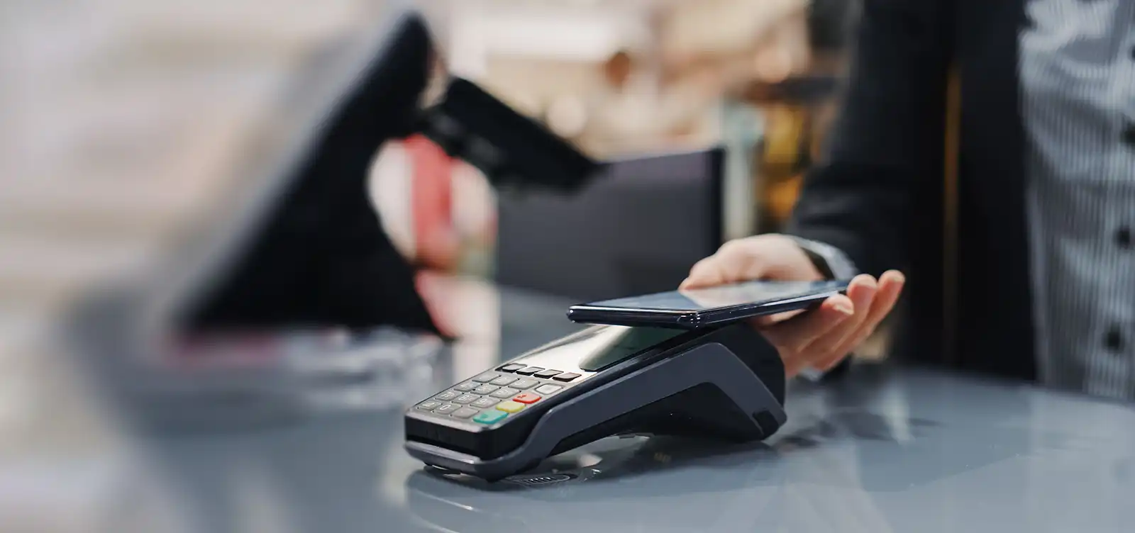 Woman paying at retail store with her smart phone