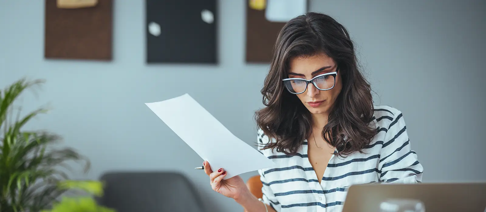 business person who keeps a paper account using a calculator manages the accounts finances