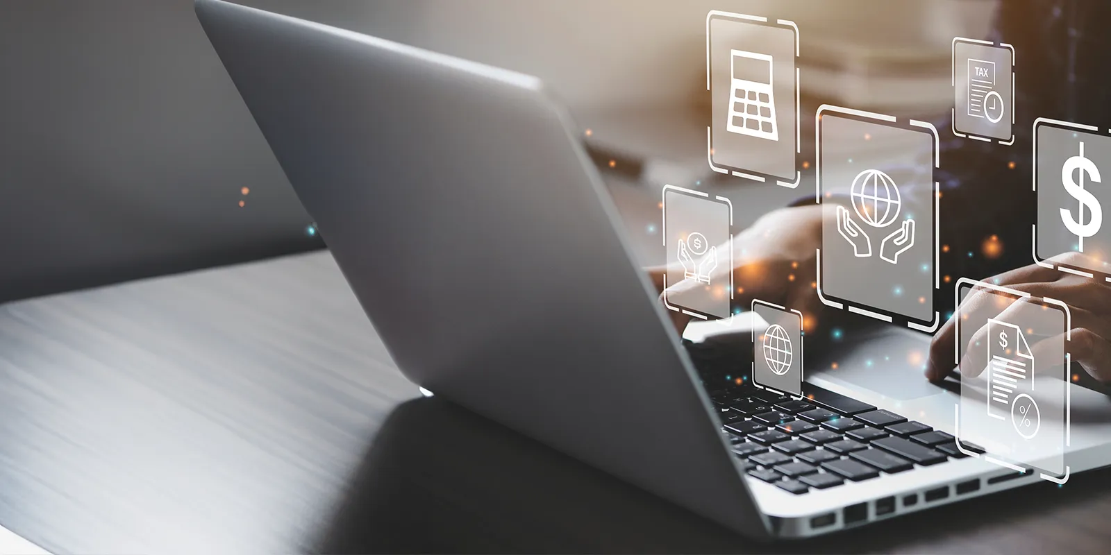 business person working on a laptop with charity and tax icons overlaid.