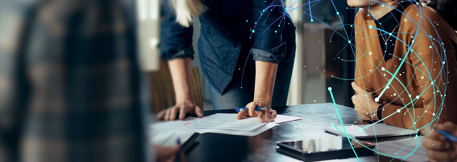 Business people reviewing documents on desk